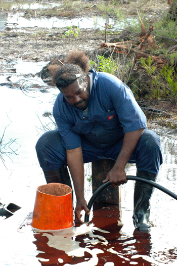 Emergency-worker-vaccuming-diesel-fuel-in-Eleuthera.jpg