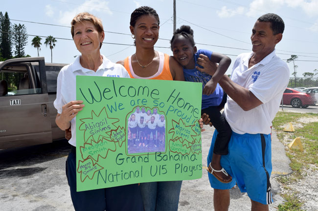 Grand-Bahama-Coaching-staff-hold-up-sign-welcoming-their-players-back.jpg