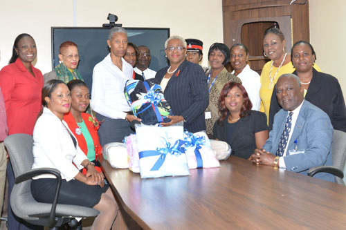 Kay-Smith_-Director-of-Human-Resources-and-Community-Relations-Presenting-the-Rand-Memorial-Hospital-With-Donated-Blankets.jpg