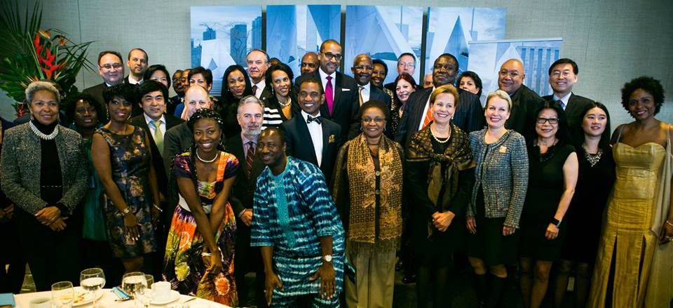 marie-claire_and_her_accompanist_join_attendees_at_the_high-level_pledging_luncheon_to_include_Deputy_Secretary_General_Jan_Eliasson-last_row_2nd_l__Ambassador_Rattray-pink_tie_and_Memorial_designer_M_Rodney_Leon-b.jpg