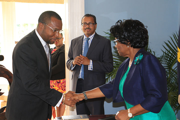 Attorney-General-shakes-hands-with-Dame-Pearlette-Louisy-as-Cabinet-Secretary-Philip-Dalsou-looks-on_.jpg
