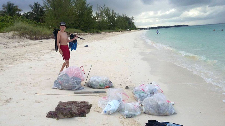 Justin-Snisky-II-surveys-the-marine-debris-collected-by----the-EARTHCARE-volunteers.jpg