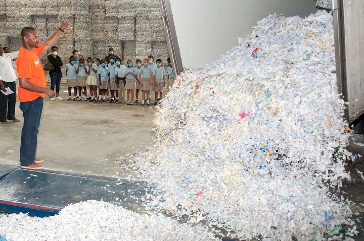 Photo-3-Shredded-paper-being-loaded-into-the-bailer-machine-to-prepare-for-export.jpg