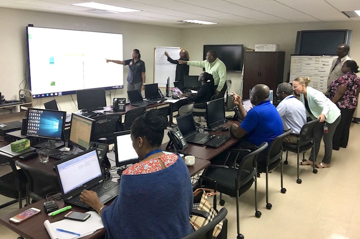 Representatives_from_the_4_Regional_Agencies_discussing_events_being_logged_into_the_Virtual_Crisis_Room_at_CDEMA_s_Regional_Coordination_Centre_.jpeg