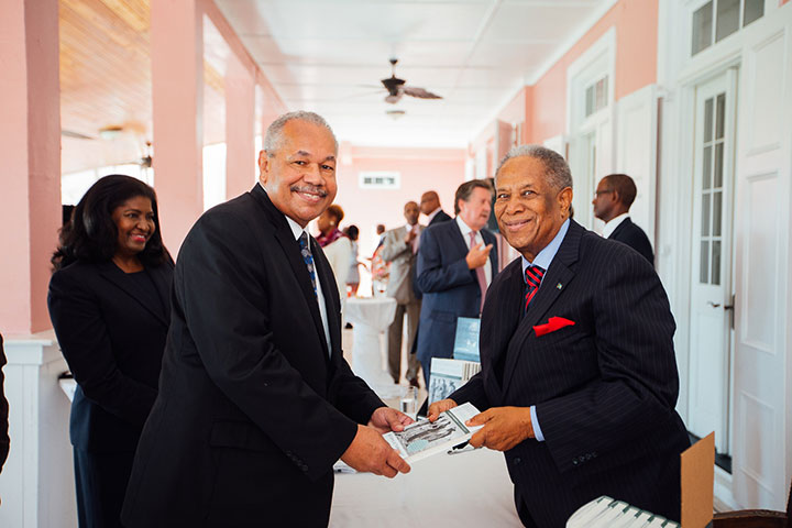 Sir-Orville-presents-a-signed-copy-of-his-book-to-Dr.-Rodney-Smith_-president-of-the-University-of-The-Bahamas.-rz.jpg