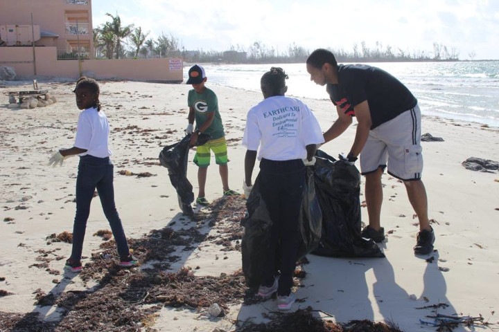 Phebe_Thompson__Kellon_Albury_and___Rizpah_Thompson_assist_EARTHCARE_Eco_KIds_Facilitator__Tyrie_M.R._Moss__with__cleaning_Williams_Town_Beach_f.jpg