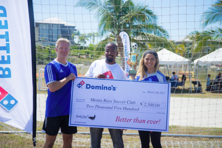 Photo_3-_Dominos_brand_manager_donates_to_the_Manta_Rays_Youth_Soccer_Program_at_Inaugural_Tournament_.jpg