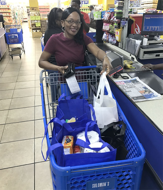 Photo_Caption_1-Shopper_using_recycled_bags_at_last_year_s_BYOB_initiative_on_Grand_Bahama.jpg