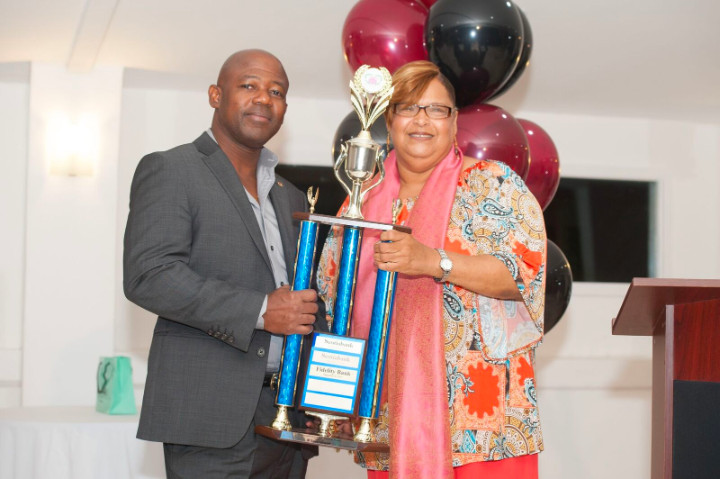 kim_bodie_bifs_executive_director_awards_crestwell_gardiner_vice_president_fidelity_bank_bahamas_limited_with_floating_trophy.jpg