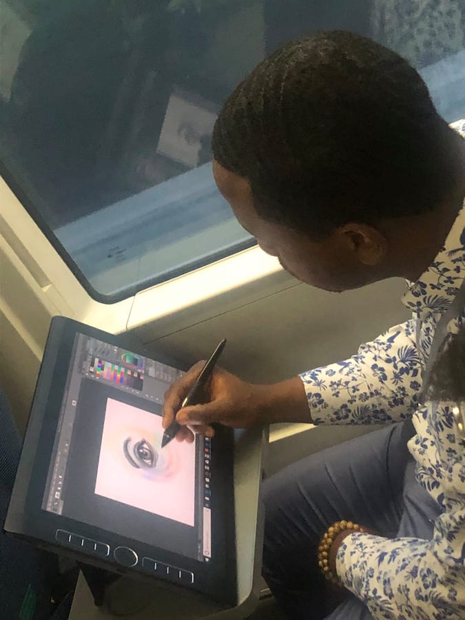 3_Jamaal_drawing_eye_for_A_Vision_United_on_the_train.jpeg