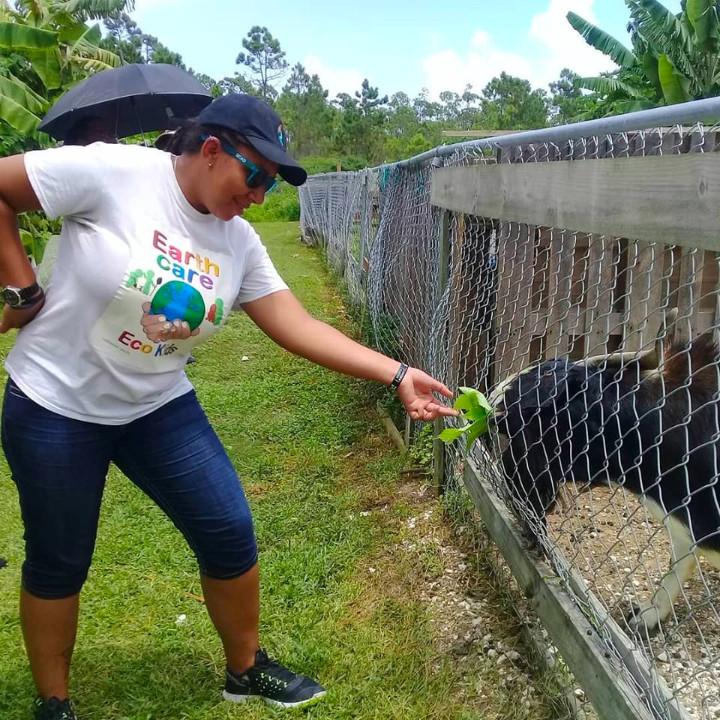 Candice_Woon__EARTHCARE_Eco_Kids________Facilitator_feeds_a_male_breeder_goat_at_Ol__Freetown_Farm.jpg