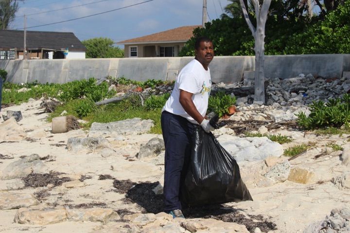 George_Williams__EARTHCARE___________Volunteer_and_Resident_of_Williams_Town_working_at_the_EARTHCARE_____World_______Oceans_Day_2019_Beach_Cleanup.jpg