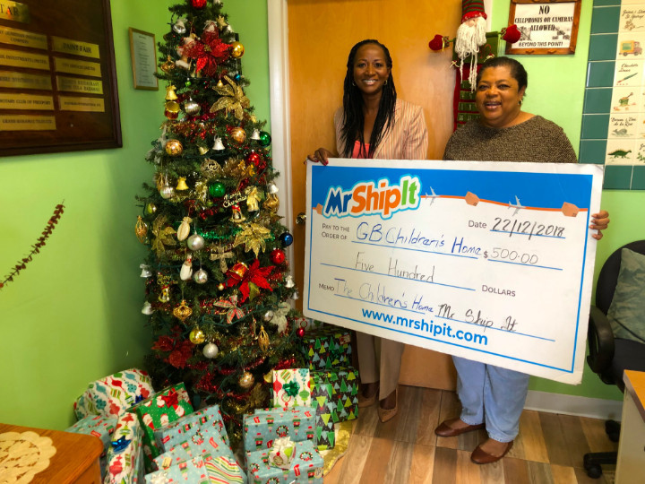 Mr_Ship_It_Freeport__Manager_presenting_gifts_and__500_Donation_to_the_Grand_Bahama_Children_s_home.jpg