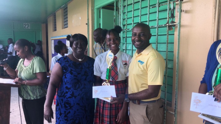 Super_Student_Debbie_Simeon_with_6_A_s_2_B_s_along_with_Principal_Greta_Brown_and_BTCs_Antoin_Bowe.jpg