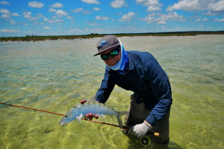 a_happy_angler_cuaght_a_fish_while_wading_in_the_flats_of_Andros.jpg