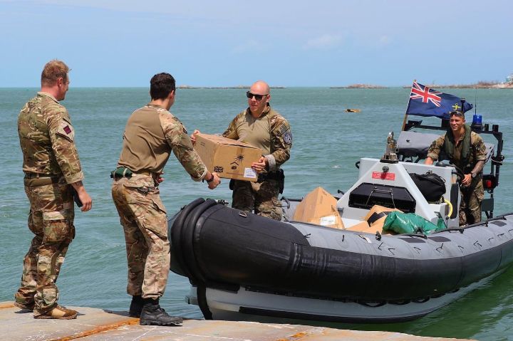 Ph_13_-_Officers_from_the_British_naval_Ship_off_load_suppplies_for_distribution_on_Wednesday_following_the_storm_1.jpg