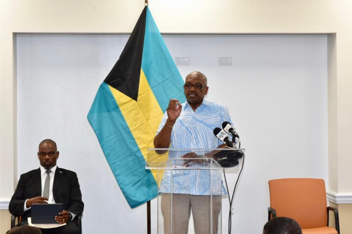 Prime_Minister_Minnis__at_podium___and_Mr._Lewis_1_-2.jpg