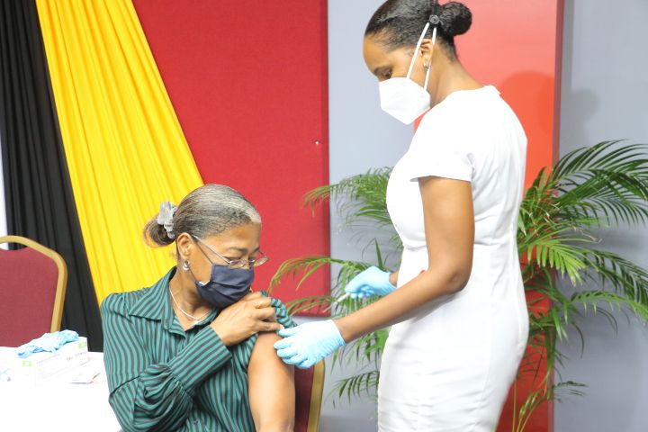 Health_and_Wellness_Minister_Hon_Mary_Isaac_supports_her_team_as_she_receives_heer_first_dose_of_the_vaccine.jpg