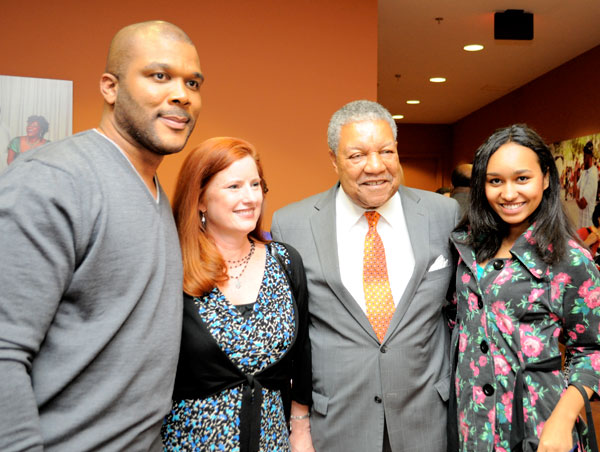Tyler Perry with guests of the tyler perry studios logo. Tyler Perry with guests of the