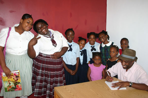 C-_KB_with_students-signing_books_at_the_launch_of_his_book_at_the_Sir_Charles_Hayward_Library_on_Friday_afternoon.jpg