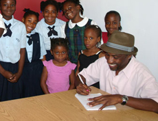 C-_KB_with_students-signing_books_at_the_launch_of_his_book_at_the_Sir_Charles_Hayward_Library_on_Friday_afternoon_1.jpg
